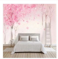 a bedroom with pink trees painted on the wall and white bed in front of it