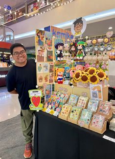 a man standing in front of a table full of toys