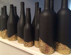 black bottles with gold glitter lined up on a shelf