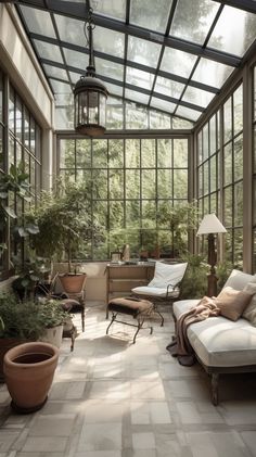 a sun room filled with lots of plants and furniture