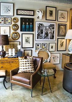 a living room filled with furniture and pictures on the wall