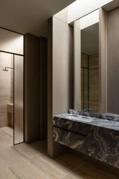 a bathroom with two sinks and mirrors in it's walls, next to a walk - in shower