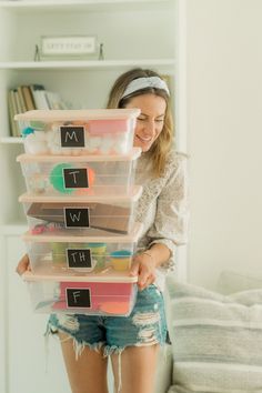 a woman is holding some plastic containers in her hands