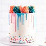 a white cake with colorful icing and sprinkles