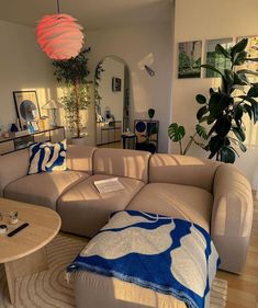 a living room filled with furniture and a large lamp hanging over the top of it