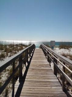 a wooden walkway leading to the beach