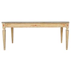 an antique console table with marble top and gold trimmings on the legs, against a white background