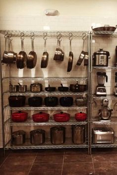 the shelves are full of pots and pans