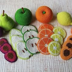 crocheted fruits and vegetables are arranged on the table top, ready to be used as decorations