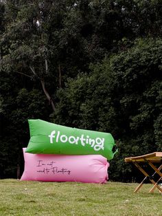 an inflatable float sitting on top of a field next to a picnic table