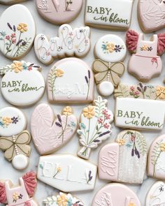 baby in bloom cookies are arranged on a table with name tags and other decorated cookies