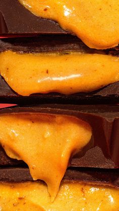 two pieces of chocolate covered in yellow icing