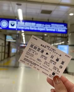 someone holding up a ticket in an airport