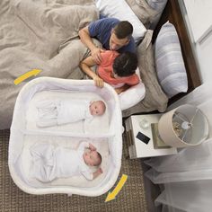 an overhead view of two babies in their crib