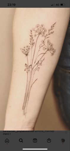 a woman's arm with some flowers on it