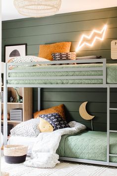 a bunk bed in a room with green walls and white rugs on the floor