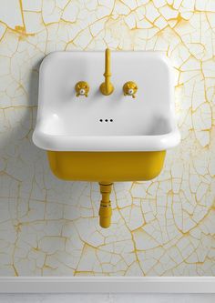 a white sink sitting next to a yellow wall