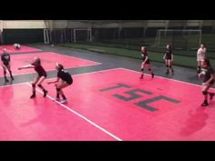 a group of people on a court playing soccer