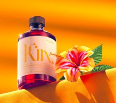 a bottle of gin next to a flower on a yellow cloth with the word gin printed on it