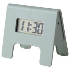 an alarm clock sitting on top of a white stand with the time 11 20 in it