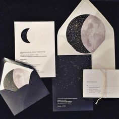 an open envelope with the moon and stars on it, along with two matching cards