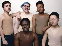 a group of young men standing next to each other in front of a white wall