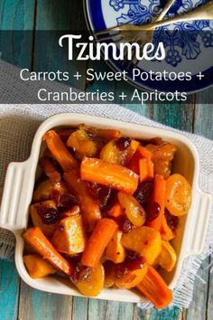 carrots and sweet potatoes with cranberries in a casserole dish on a wooden table