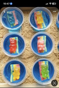 six plastic plates with gummy bears in them