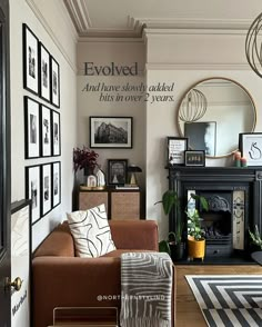 a living room filled with furniture and pictures on the wall next to a fire place