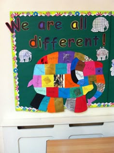 an elephant made out of different colored pieces of paper on a green board with the words we are all different