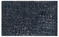 an area rug with dark blue and grey colors