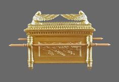 an ornate gold casket with two birds on top