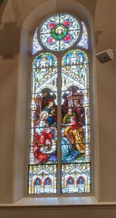 a stained glass window in the corner of a room