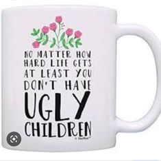 a white coffee mug with the words ugly children written on it and flowers in black ink