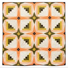 an orange and white quilt with squares in the shape of rectangles on it