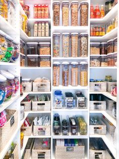 an organized pantry filled with lots of food and drinks, including cereals in containers