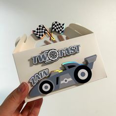 a person holding up a card that says iwo fast and an image of a race car