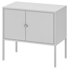 a white cabinet with two doors and legs