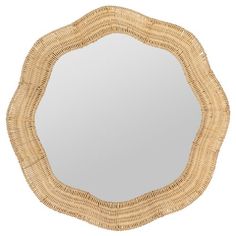 a round mirror made out of wicker with a white background and light brown trim