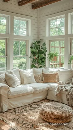 a living room filled with lots of white furniture