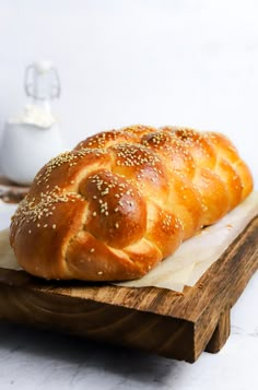 a loaf of bread sitting on top of a wooden cutting board