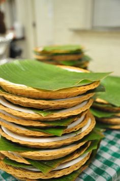 a stack of banana leaves sitting on top of a green and white checkered table cloth