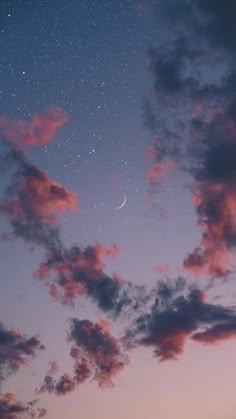 the sky is filled with stars and clouds as the moon shines in the distance