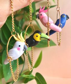 Handmade hanging bird earrings. Made from polymer clay. Lightweight. Great for summer, tropical vacations, or just because. Options include colorful parrots, cockatoos, and toucans. Perfect for bird lovers, those who love quirky eclectic finds, and fans of tropical areas. | Hanging Bird Earrings, Parrot Earrings, Toucan Jewelry, Cockatoo Earring, Tropical Bird Earrings, Summer Jewelry, Unique Earrings Toucan Earrings, Parrot Earrings, Clay Bird, Quirky Earrings, Colorful Parrots, Tropical Bird, Funky Earrings, Love Animals, Ceramics Projects