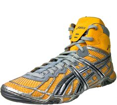 a pair of yellow and grey sneakers on a white background