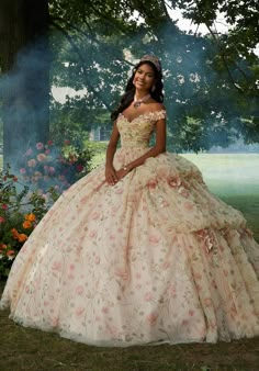 Embrace your inner fairytale princess with this whimsical Vizcaya quinceaera ball gown (style 89457). The delicately draped bodice features classic off-the-shoulder sleeves accented by stunning crystal beaded, three-dimensional flowers that add a touch of whimsy. The real magic lies in the skirt, crafted with a stunning combination of floral printed tulle layered over luxurious sparkle tulle. This creates a dimensional effect that shimmers with every move. Pickups in the skirt create a cascading waterfall look, further adding to the whimsical feel. Three-dimensional flowers are scattered throughout the skirt, echoing the details on the bodice and tying the whole look together. To complete your regal presence, a matching stole is included. This dress is sure to make you feel like a quinceae Allure Couture, Pretty Quinceanera Dresses, Quince Dress, Sherri Hill Prom Dresses, Theme Dress, Mori Lee, Corset Bodice, Sherri Hill Dresses, Allure Bridal