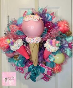 an ice cream cone wreath is hanging on the front door, decorated with pastel colors