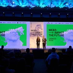 two people standing on stage in front of large screen with words that read webs impact the future