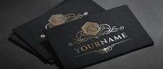 two black business cards with gold foil on them