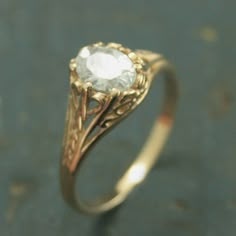 a gold ring with a white diamond in it